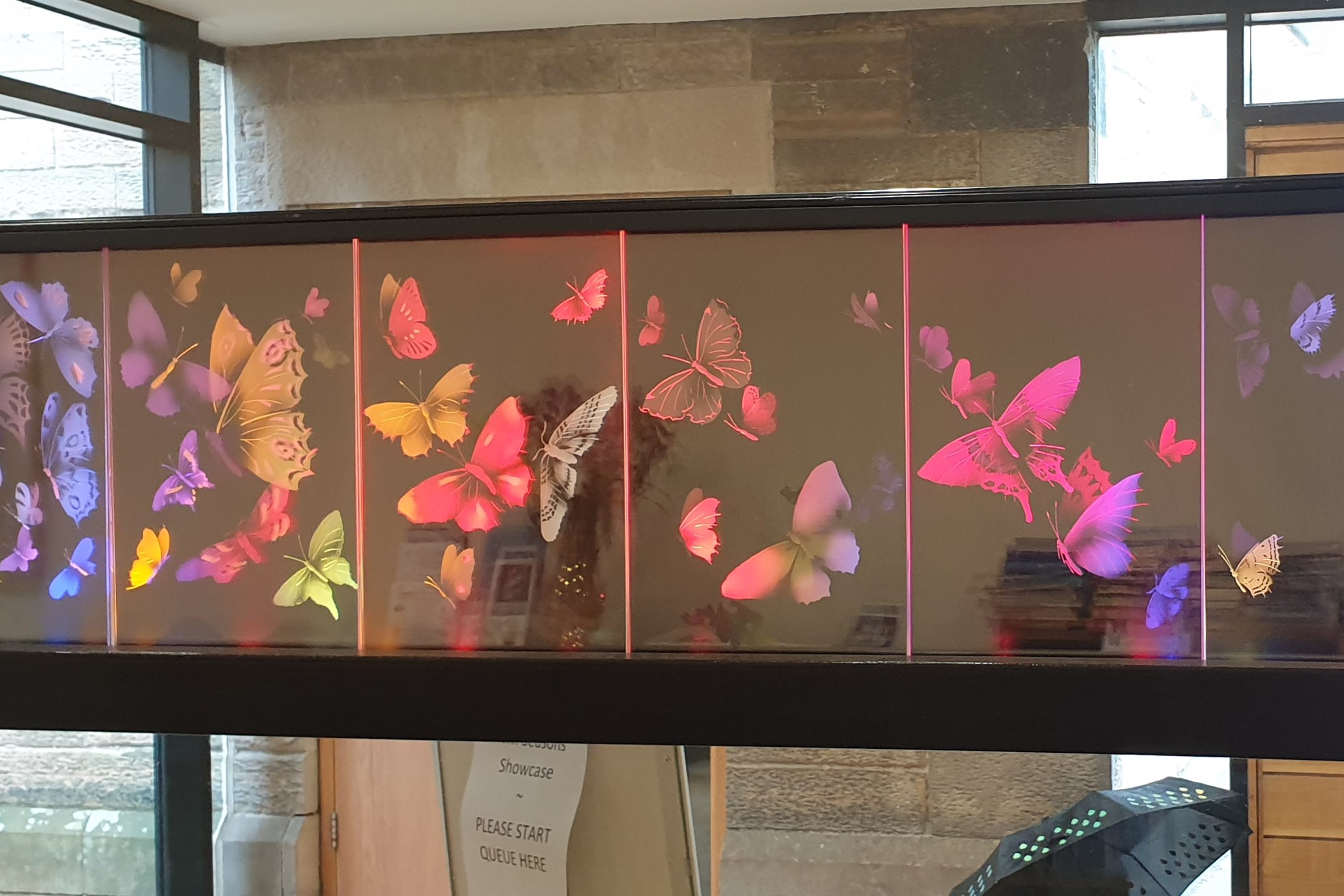 A lit glass panel depicting butterflies.