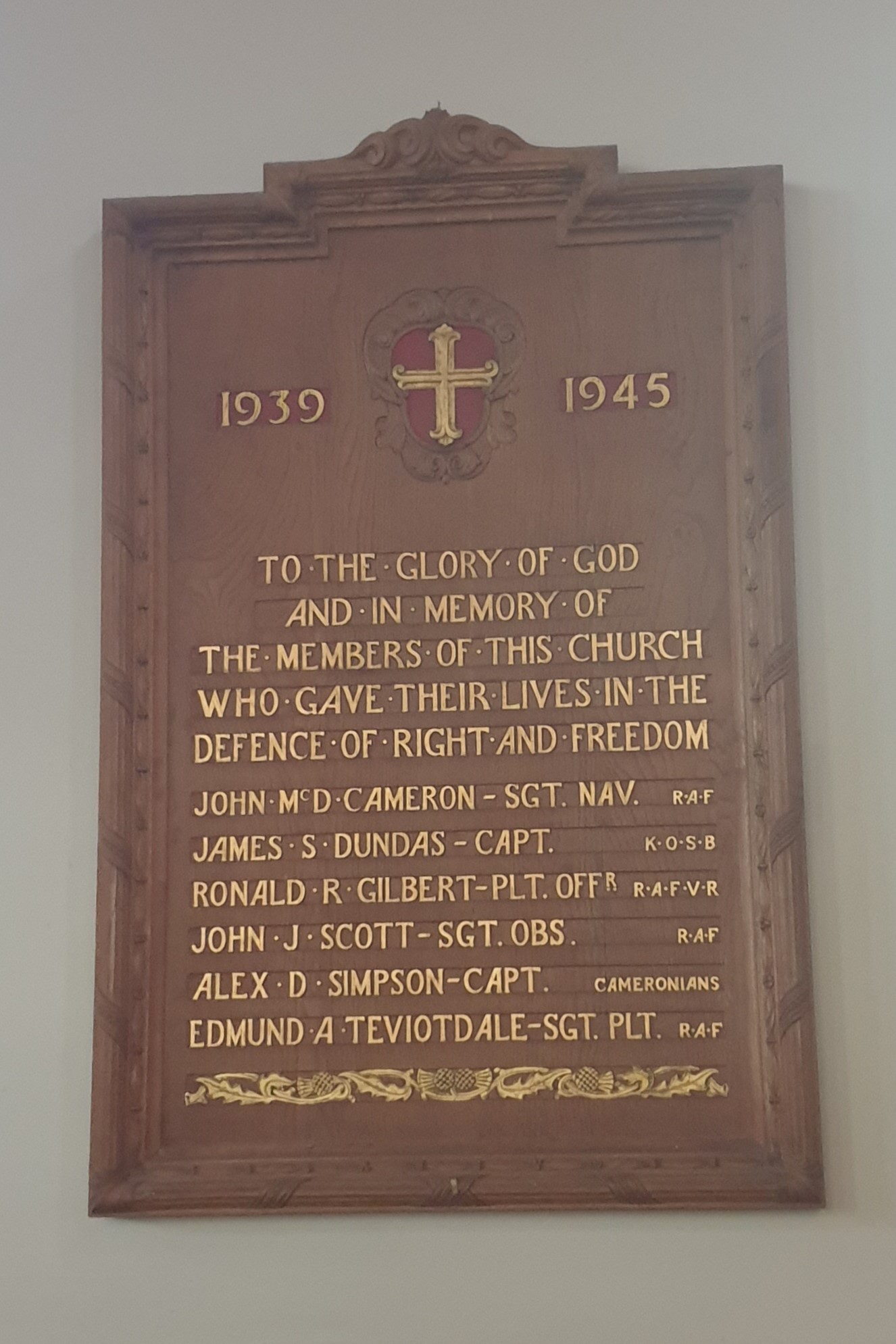 A wooden war memorial commemorating those from the parish who fell in the second world war.