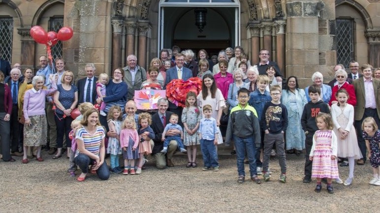 A picture of the congregation standing outside the church for a photograph.